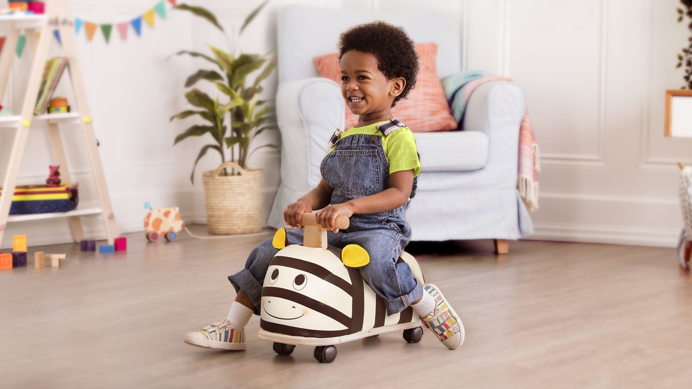 A small Kid playing with Bee Ride-on toy